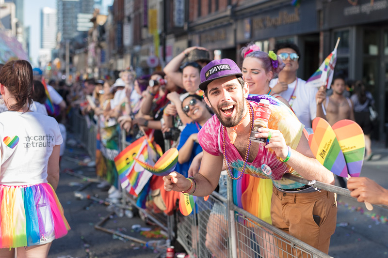 People cheering the pride parade on Yonge Street, Toronto