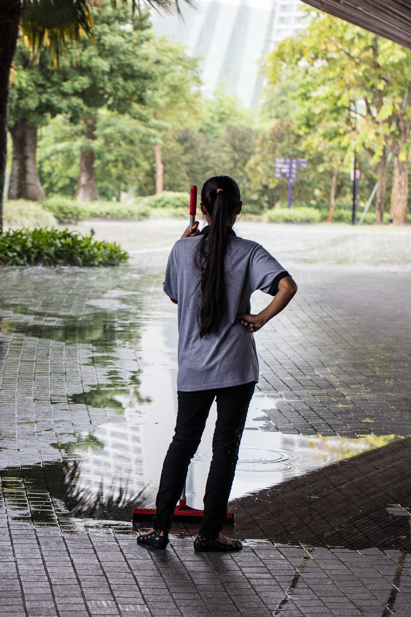 Girl waits from rain to stop, Gardens by the Bay, Singapore