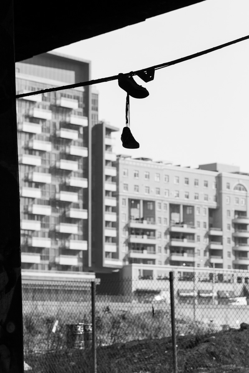 Shoes hanging from wire.