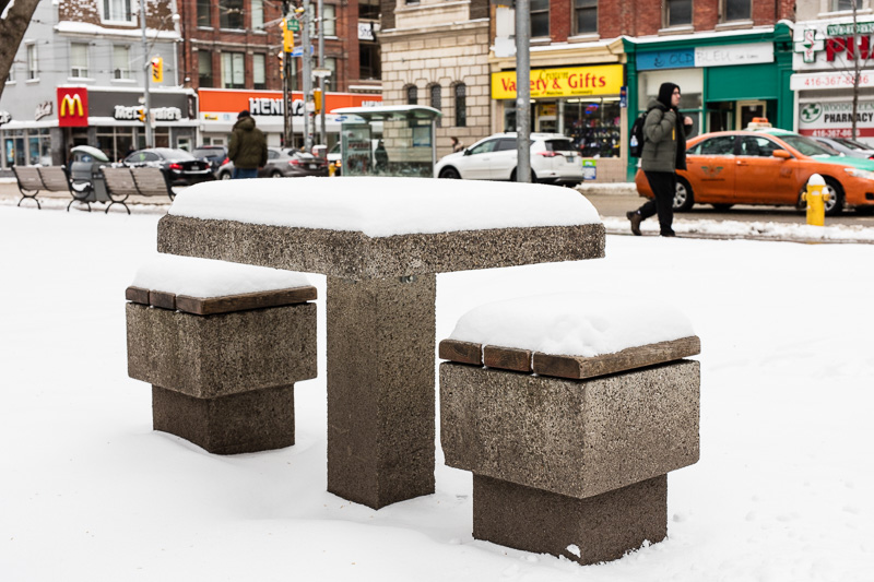 Snow-covered chess table in front of Metropolitan United Church in Toronto