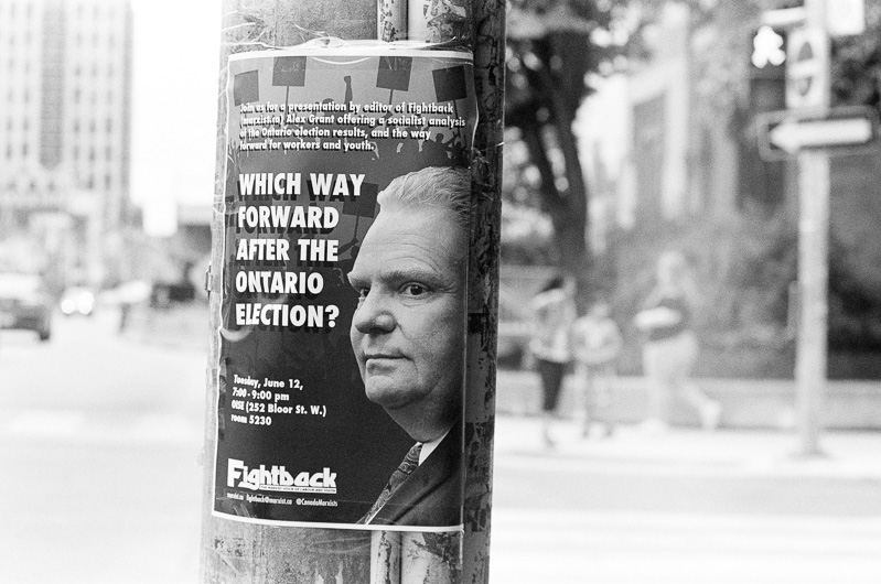 Poster with Doug Ford's face on a pole