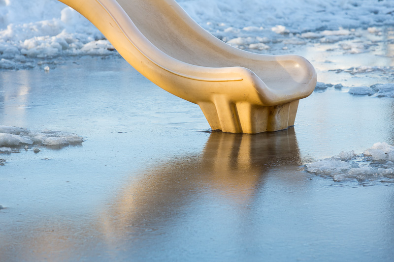 Playground slide frozen in ice
