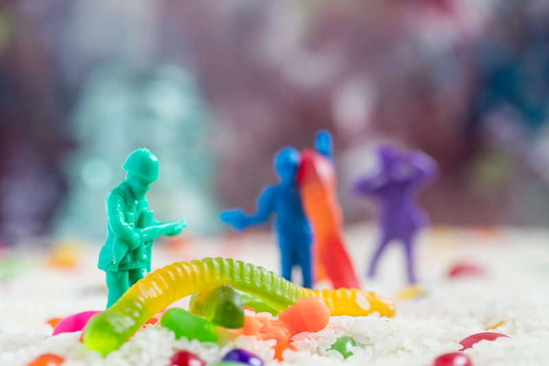 Soldiers confront gummy worms in a field of rice and jelly beans