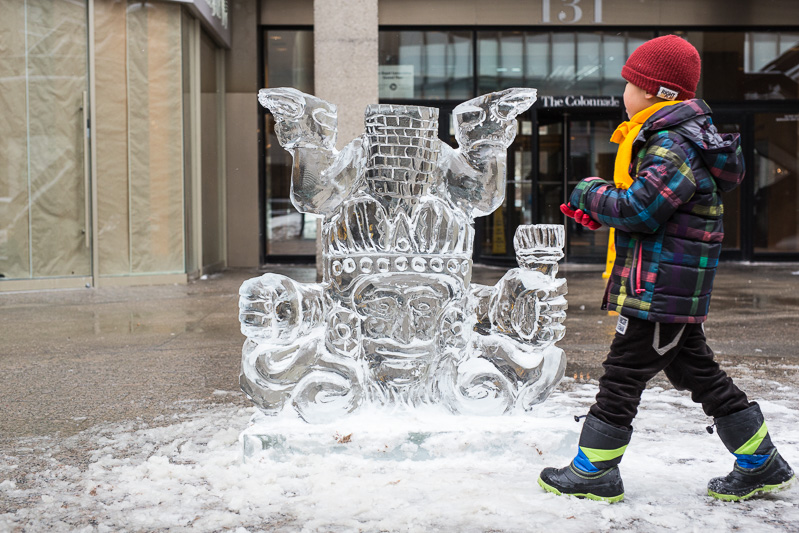 Child runs past ice sculpture