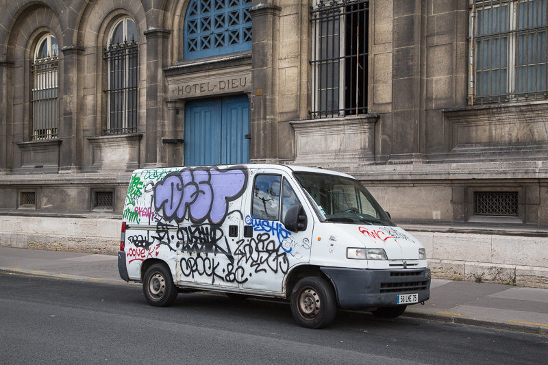 Graffiti-covered van on the Quai de la Corse