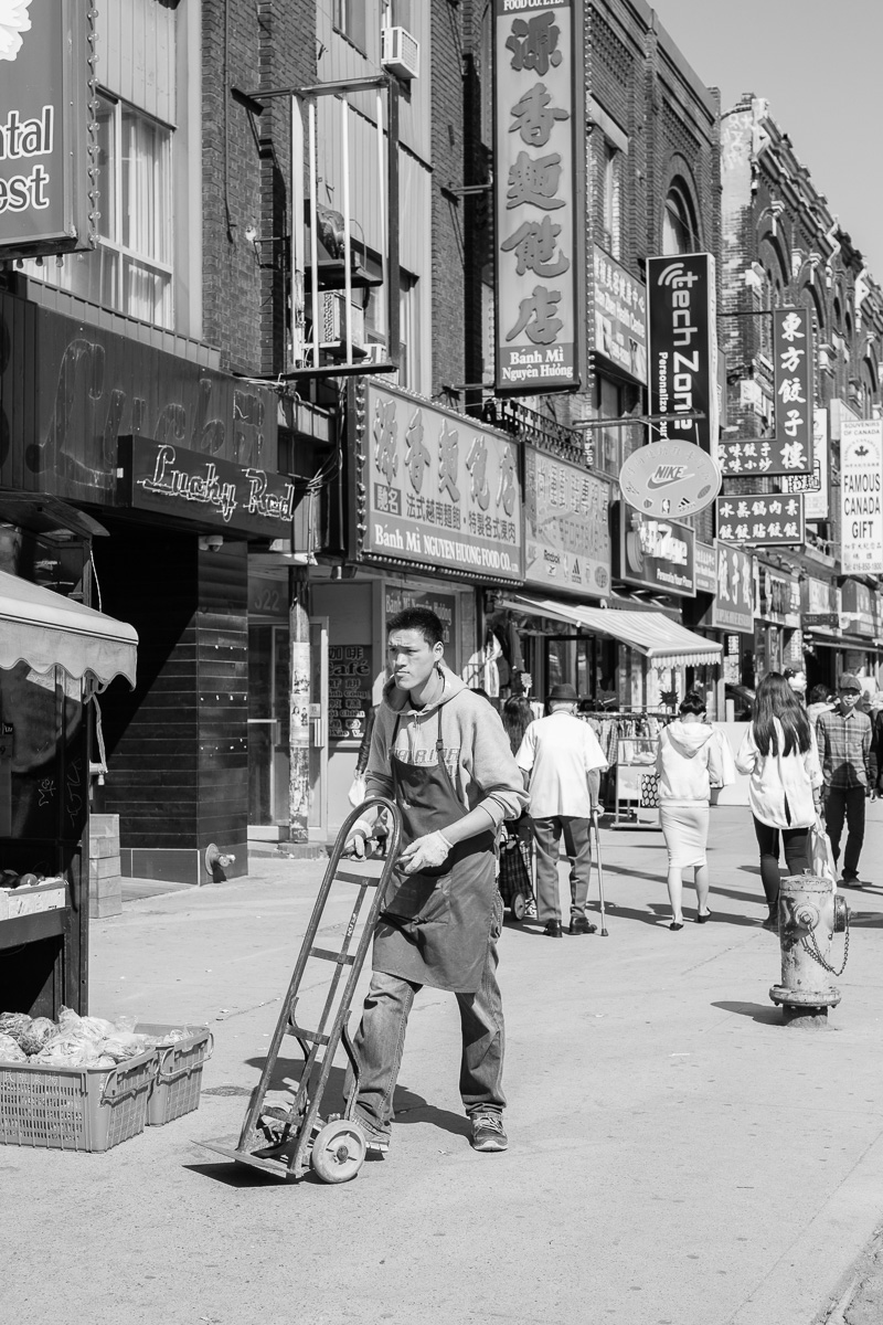 Pushing a dolly in Chinatown.