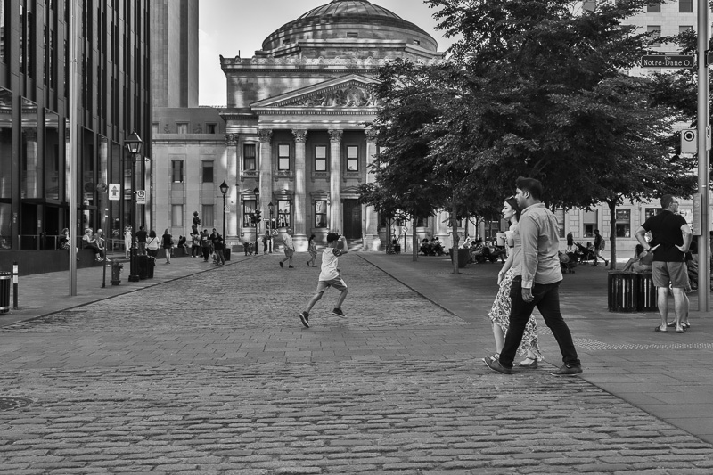 Child crossing Place d'Armes, Montreal