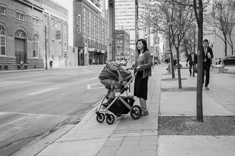 A mother pushes a stroller.
