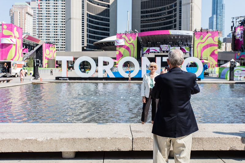 Taking photos in front of the Toronto sign in Nathan Phillips Square.