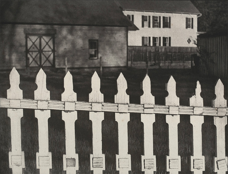 Photograph of white picket fence by Paul Strand