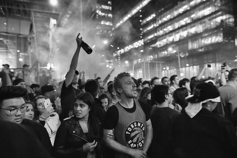 The crowd celebrates the Raptors win outside Jurassic Park, Toronto