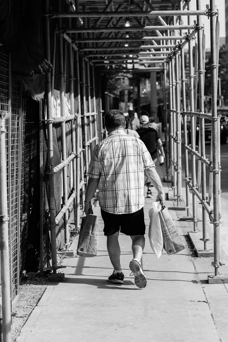 Man wearing "scaffolding" shirt on Avenue Road in Yorkville, Toronto