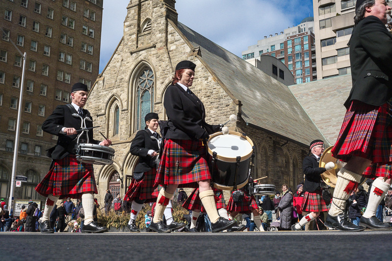 Beating a drum in front of the Church of the Redeemer at Avenue Road and Bloor Street West, Toronto
