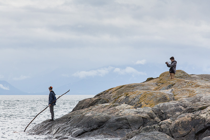 Boys taking photos on the rocks