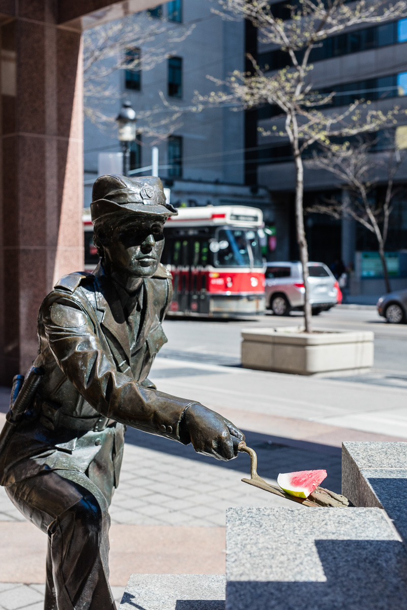 Police sculpture serving watermelon at police headquarters, Toronto