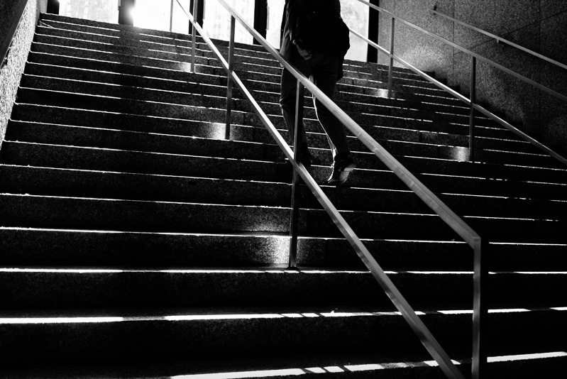 Man in suit climbing stairs