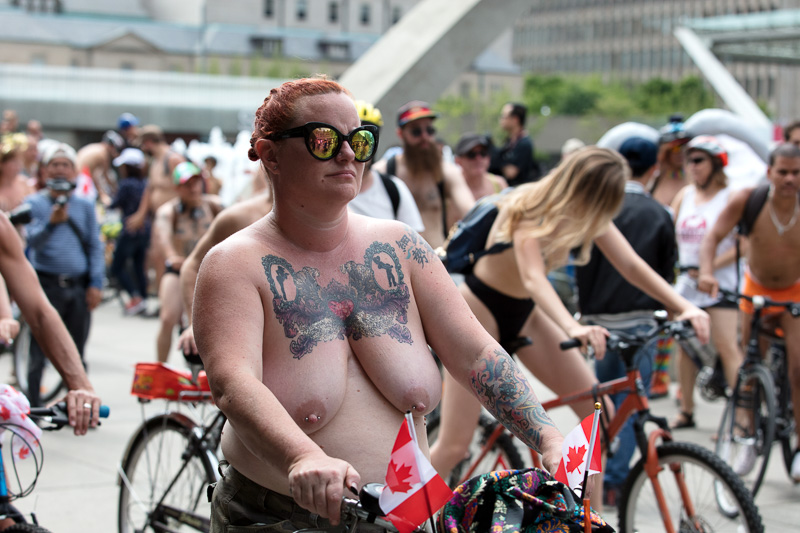 Naked woman with bicycle in Nathan Philips Square