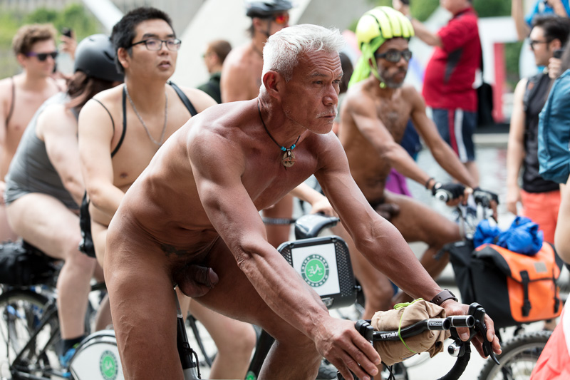 Naked man rides bicycle