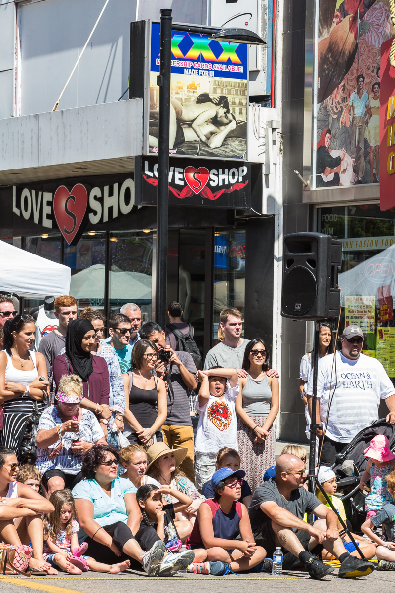 Families watch Buskerfest in front of the Love Shop