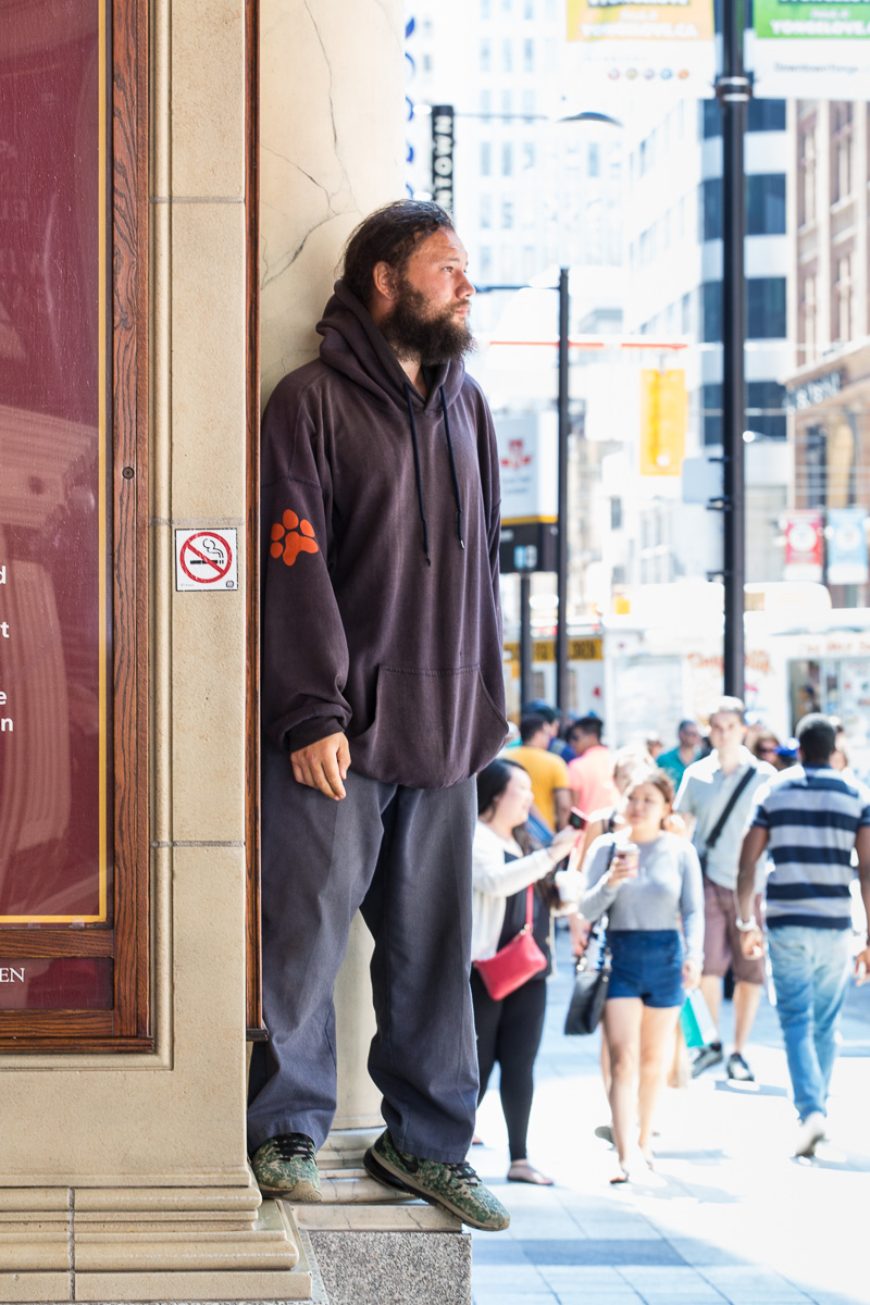 Man stands on ledge to watch what's going on