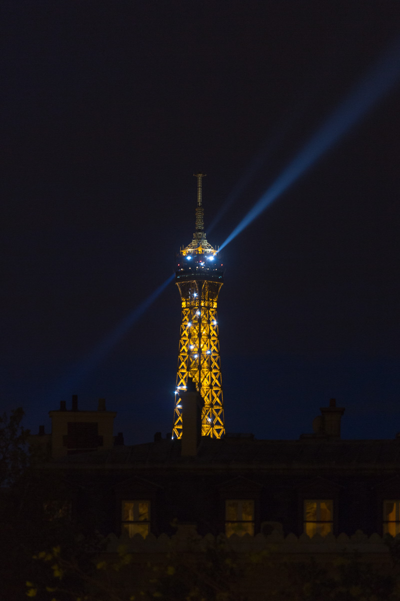 Spotlights shining from the Eiffel Tower