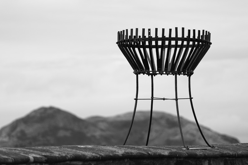 A metal fire thingy sitting on the parapets of Edinburgh castle.