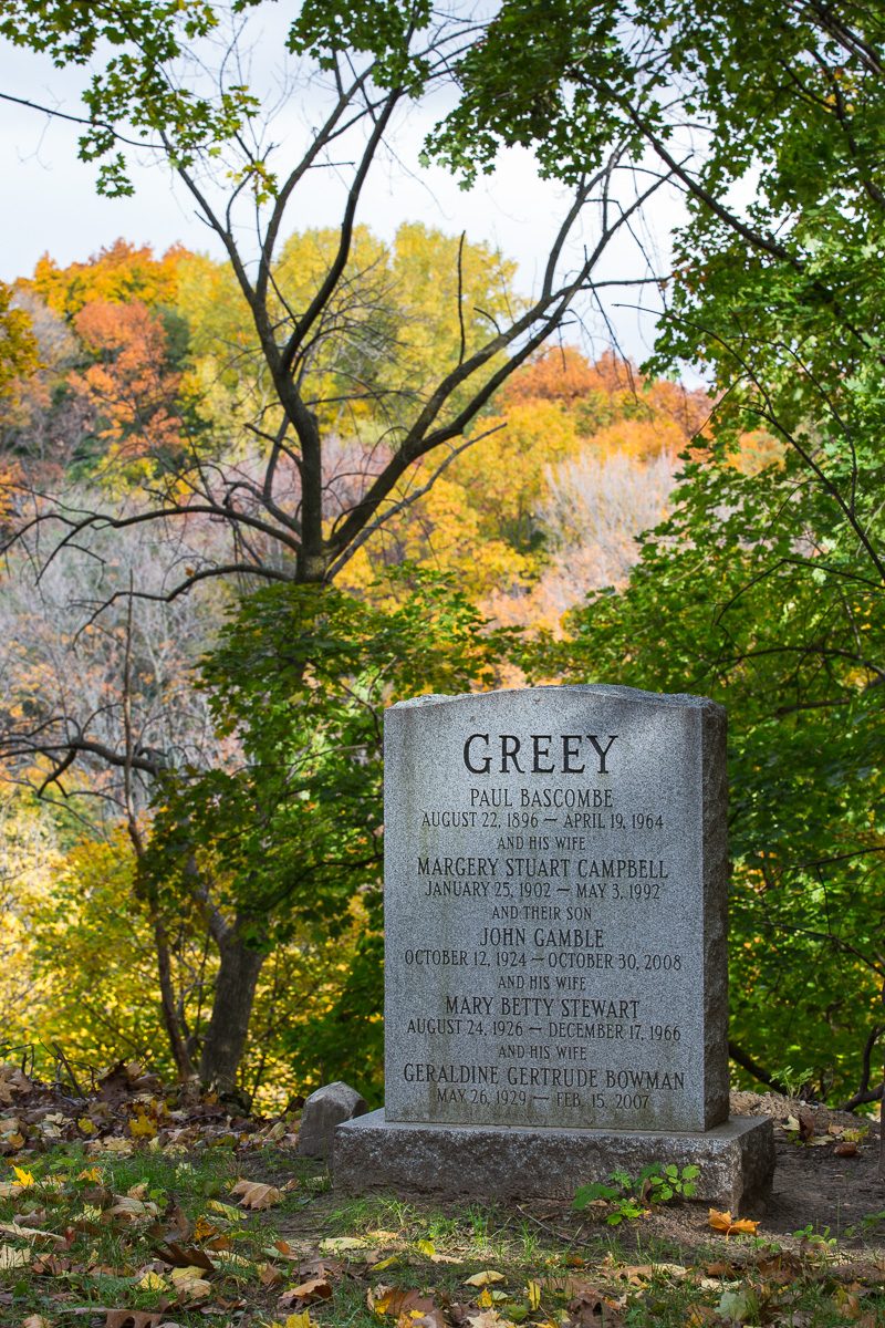 Headstone on hill overlooking autumn landscape