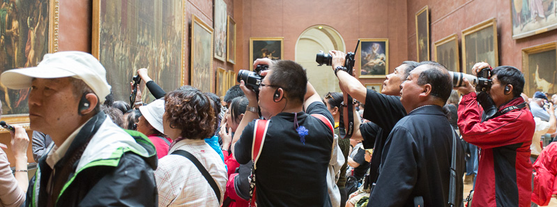 Tourists taking photos at the Musée du Louvre, Paris