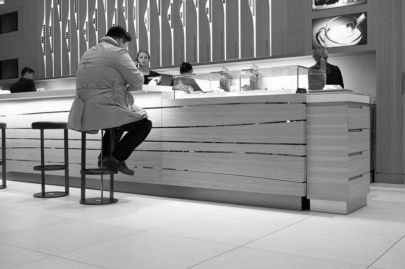 Man seated at counter in coffee bar