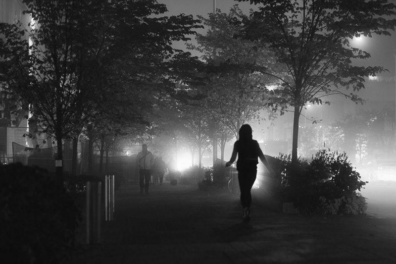 Woman walking in early morning fog