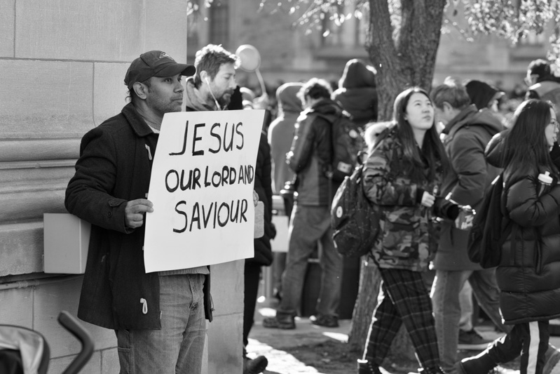 Man holds sign which says: Jesus our Lord and Saviour