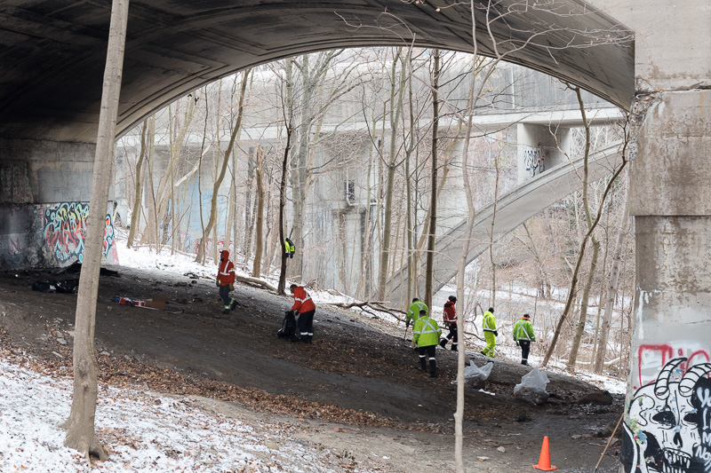 City of Toronto workers collect garbage from underneath the Bloor Street East Bridge over Rosedale Valley Road