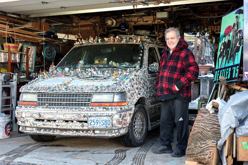 Albino Carreira standing with his decorated van.