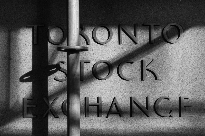 The Bay Street sign of the Toronto Stock Exchange is shaded by scaffolding