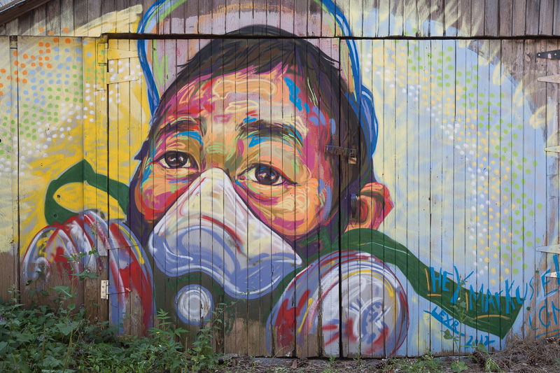 Graffiti mural of man wearing a face mask
