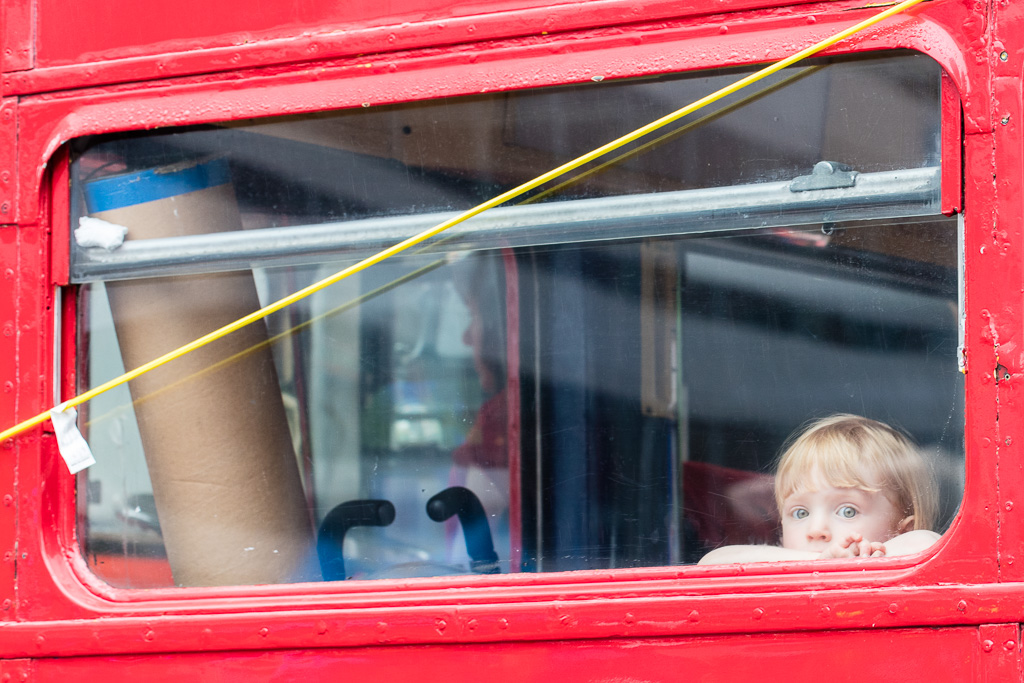 Child stares out bus window - Toronto Pride, 2015