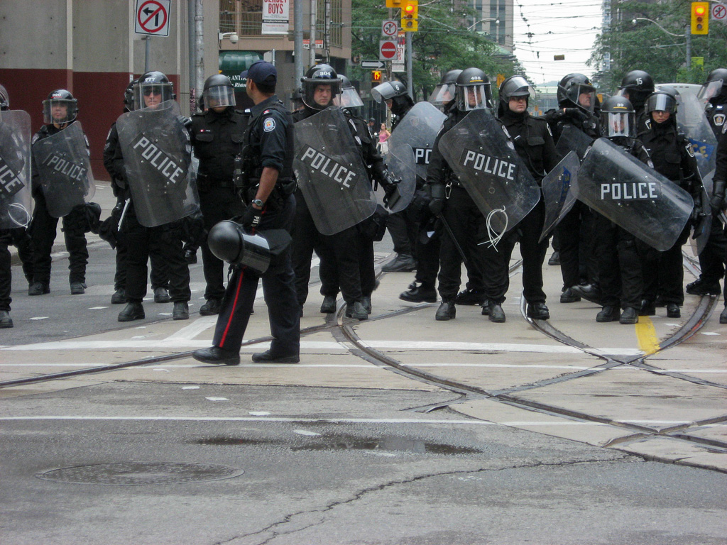 Police in riot gear stand along Queen St. W. on the north end of York St. during the Toronto G20 Summit, June 26, 2010