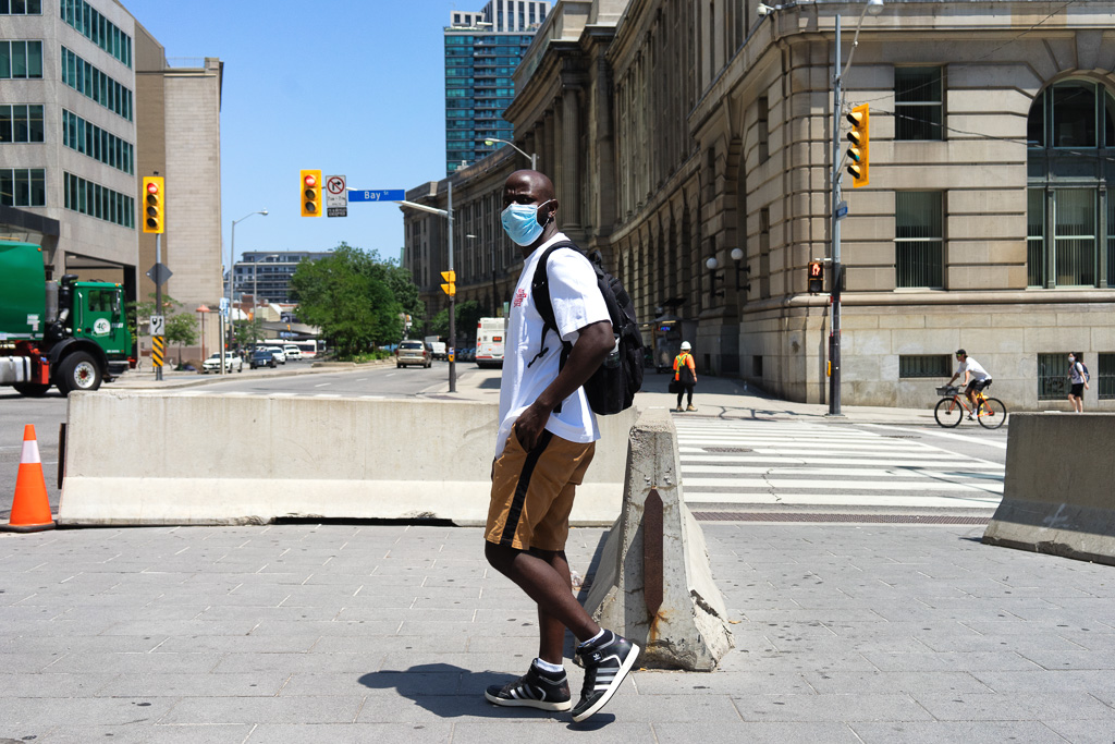 Man wearing mask at Front & Bay Streets, Toronto