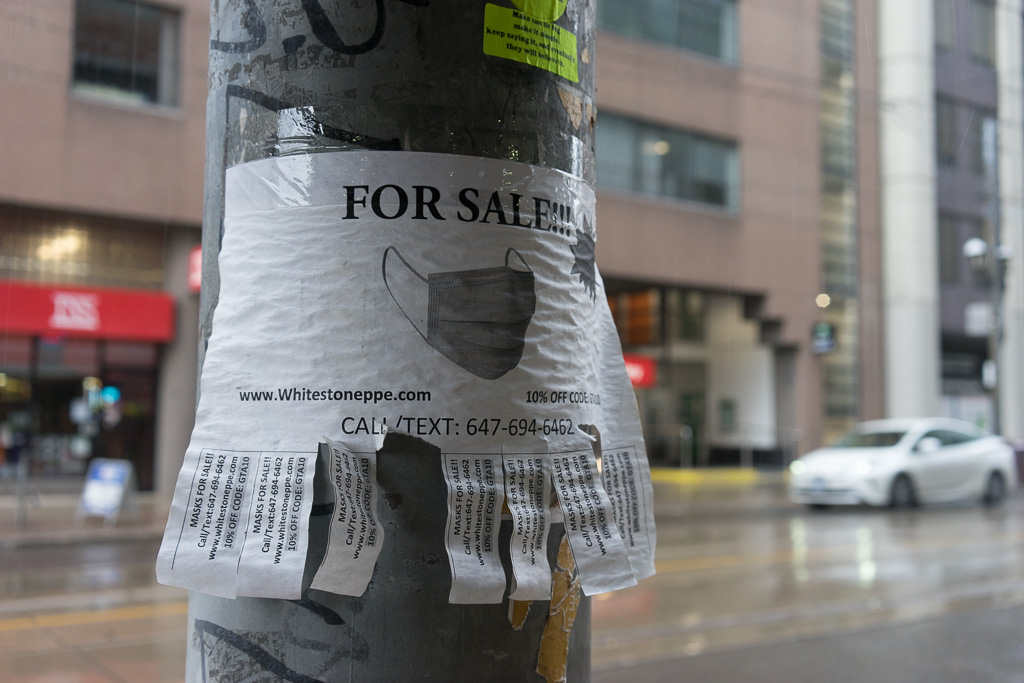 Sign taped to utility pole selling masks