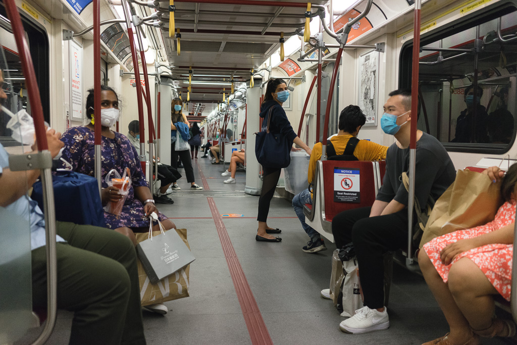 People ride the Toronto subway while wearing masks