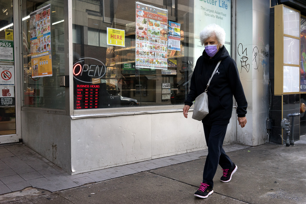 Woman wearing a purple face covering.