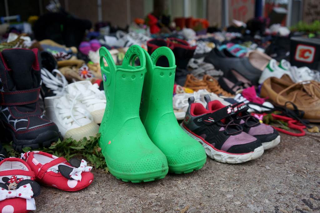 Children's green rubber boots at former site of the Egerton Ryerson statue. A memorial to the 215 Indigenous children found in unmarked graves in Kamloops.