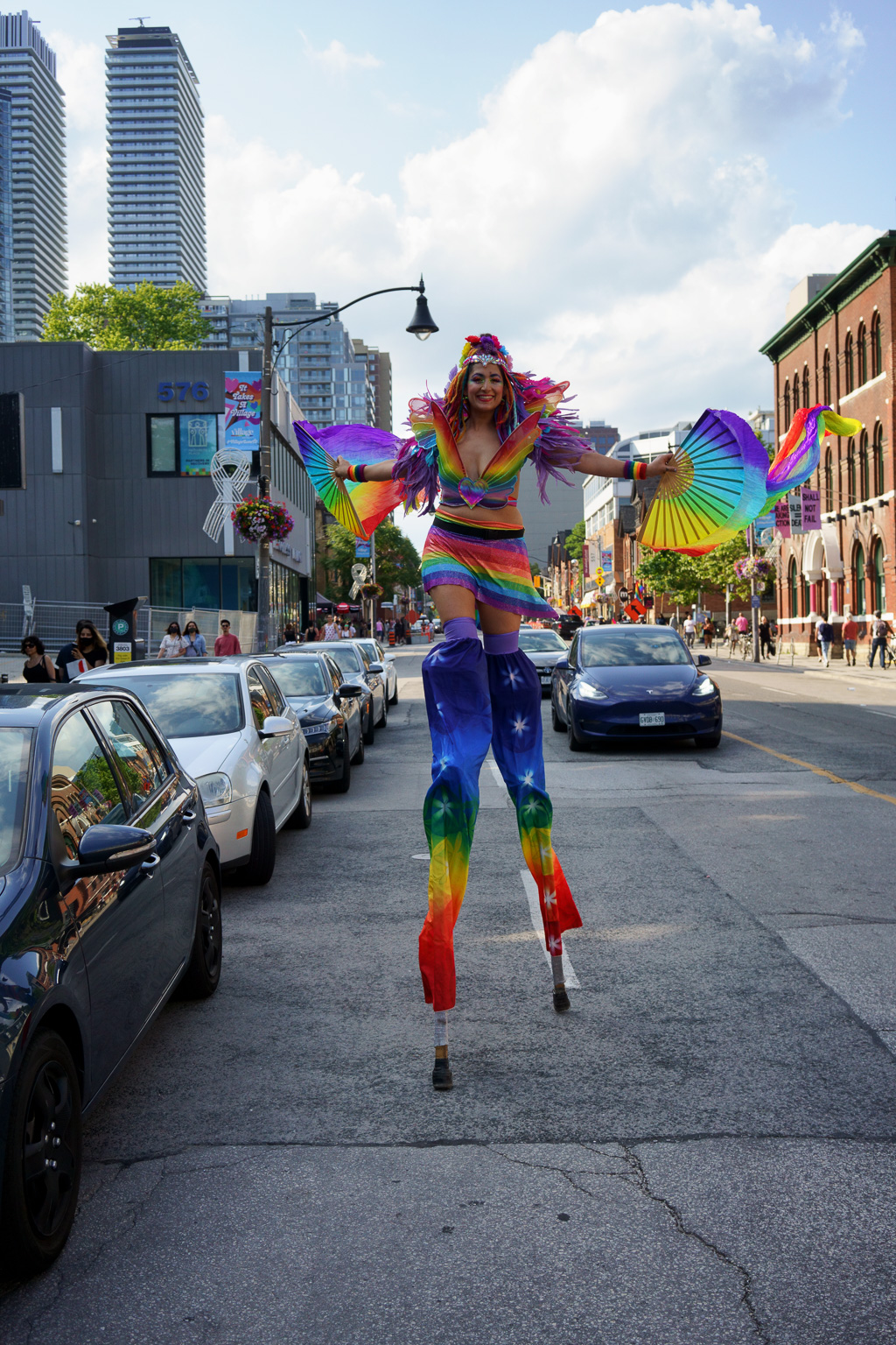 Walking on stilts down Toronto's Church Street in a rainbow dress.