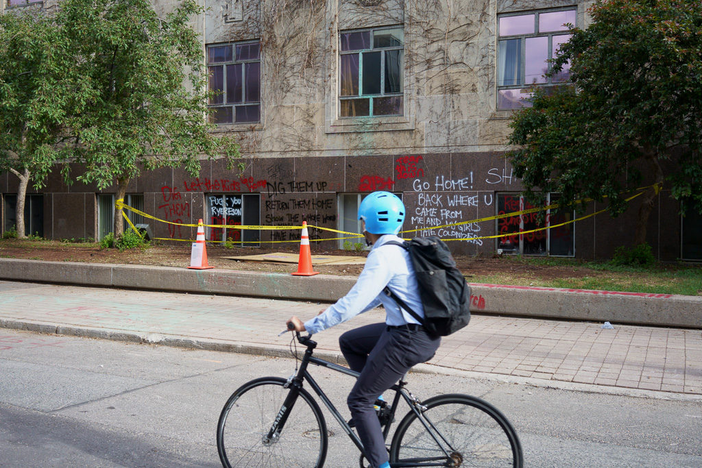 Student cycles past site on Toronto's Gould Street where statue of Egerton Ryerson used to stand.