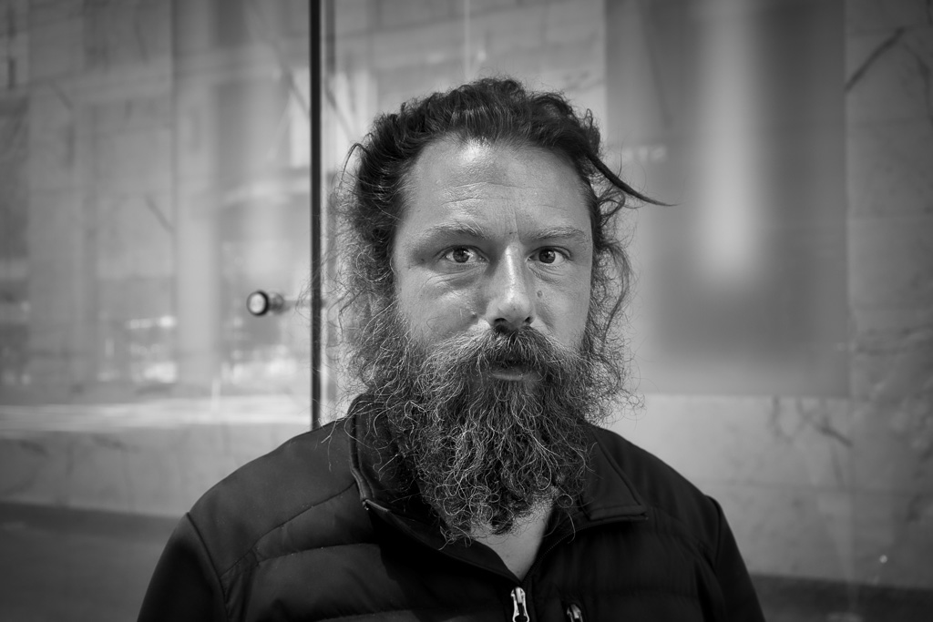Black and white street portrait of bearded man