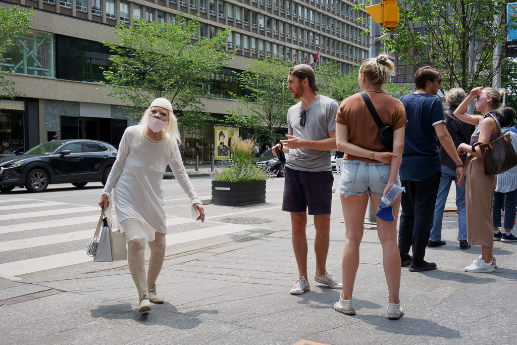 Woman crossing Bloor Street, Toronto.