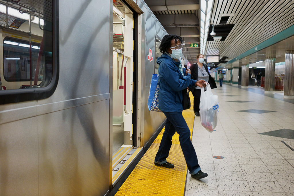 Woman exits a subway train at the Bloor/Yonge Subway Station, Toronto
