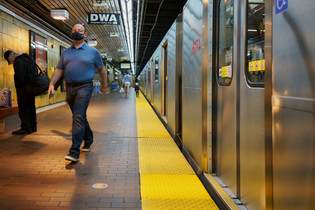 Man walks along the King Street subway station platform.