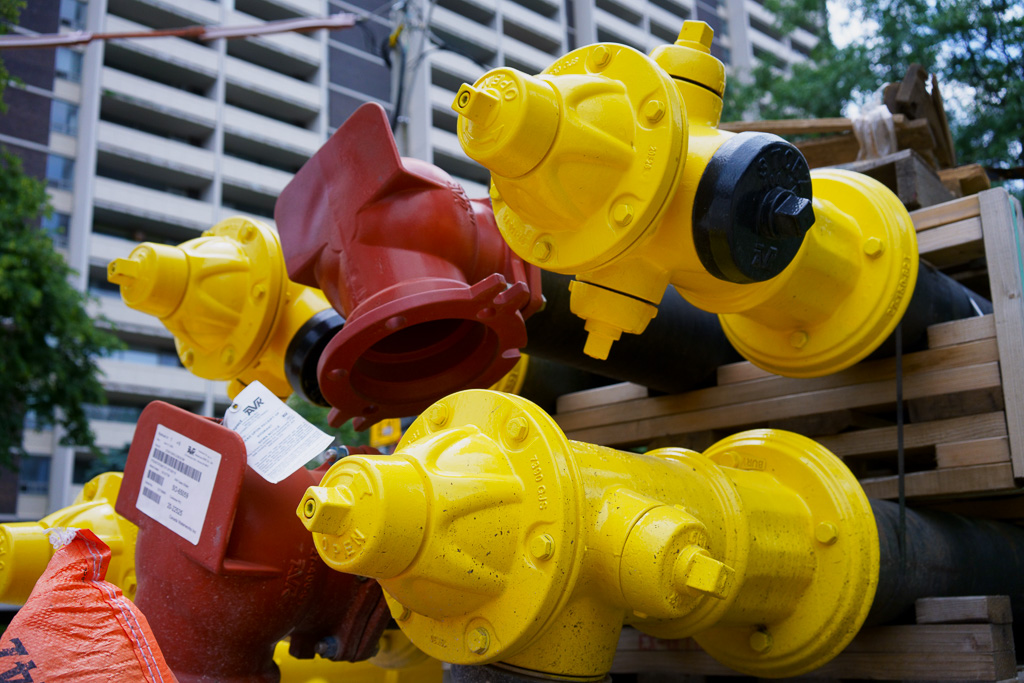 Fresh yellow fire hydrants waiting for installation.