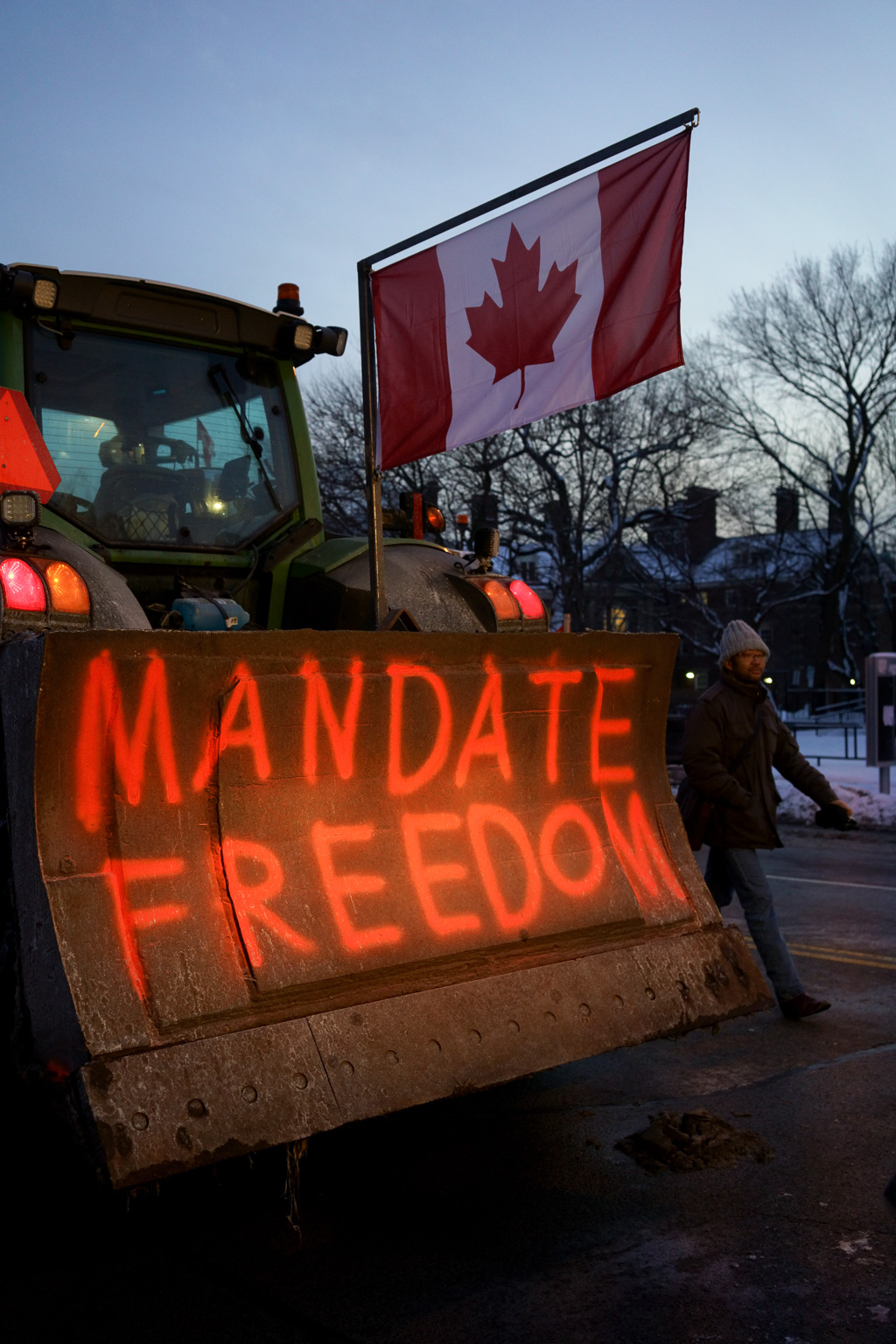 Mandate Freedom: ironic sign on a tractor parked in front of Flavelle House, Faculty of Law, University of Toronto